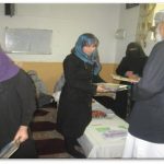 Volunteers distributing booklets in Afghanistan